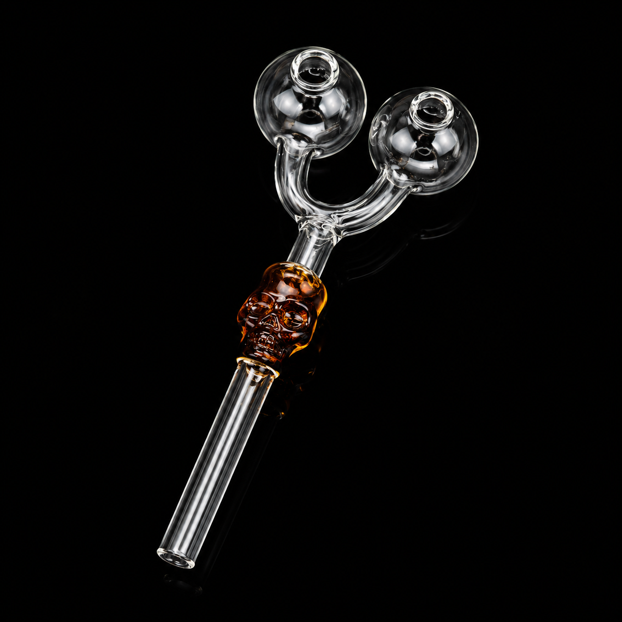 Glass smoking device with skull design on a black background