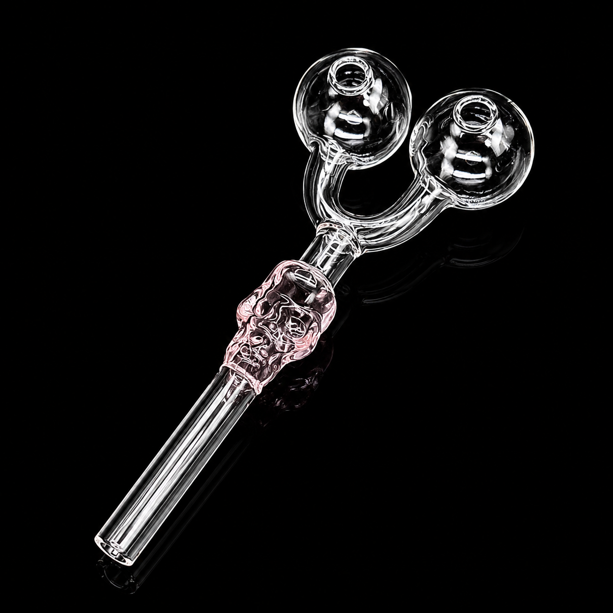 Glass smoking accessory with skull design on a black background