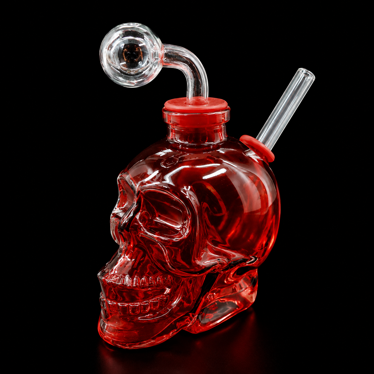 Red skull-shaped glass pipe with a smoking attachment on a black background