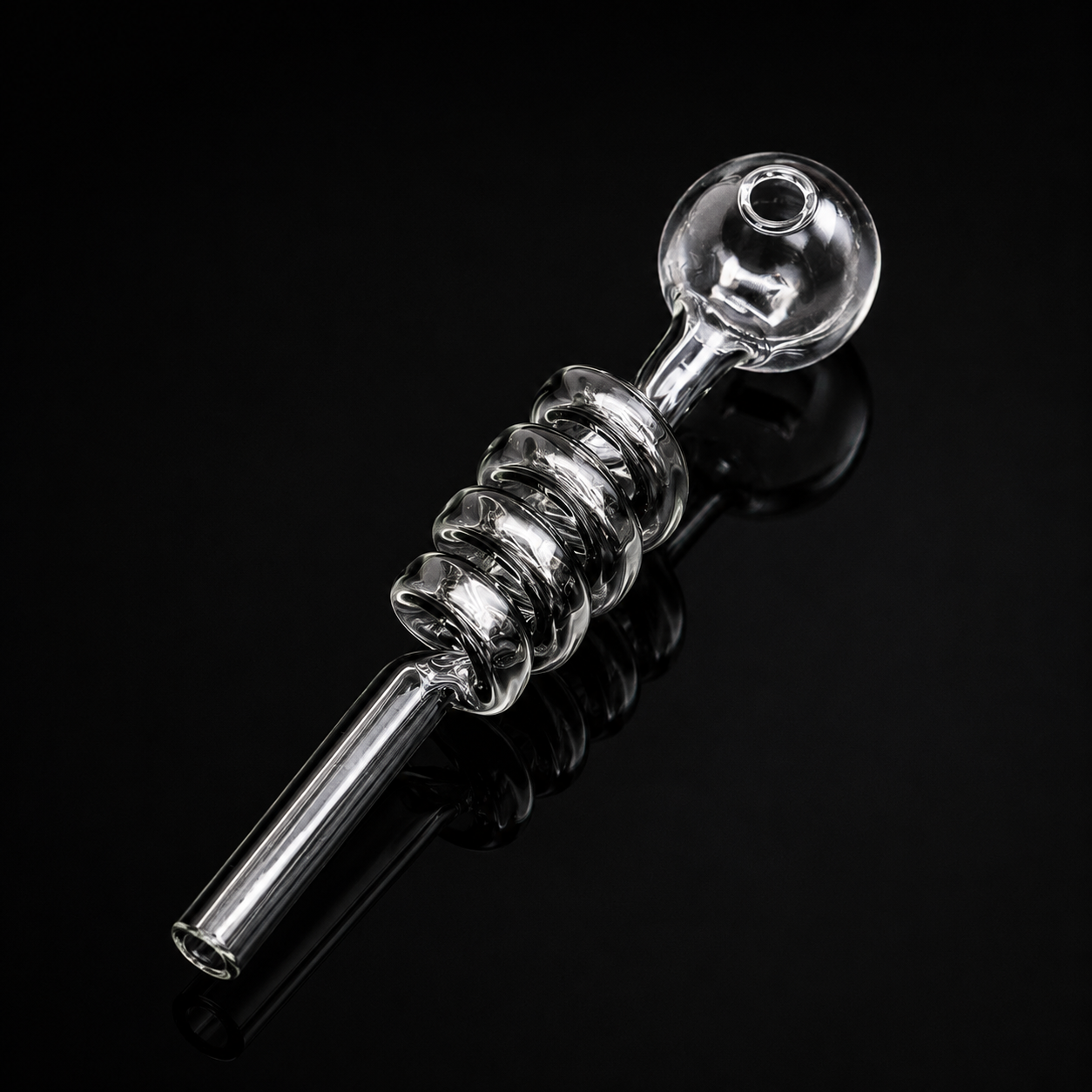 Clear glass smoking pipe on a black background