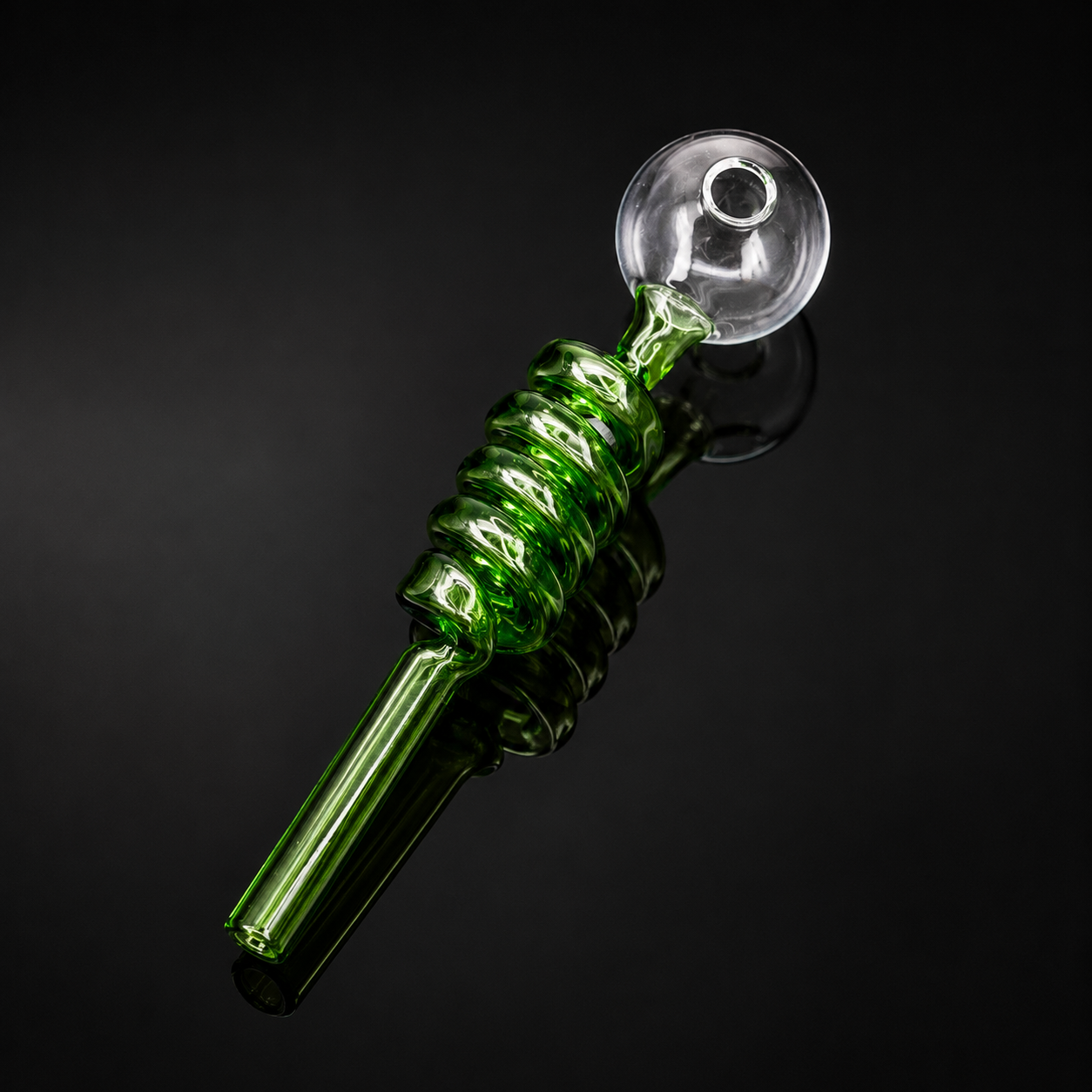 Green glass pipe with spiral design on a black background