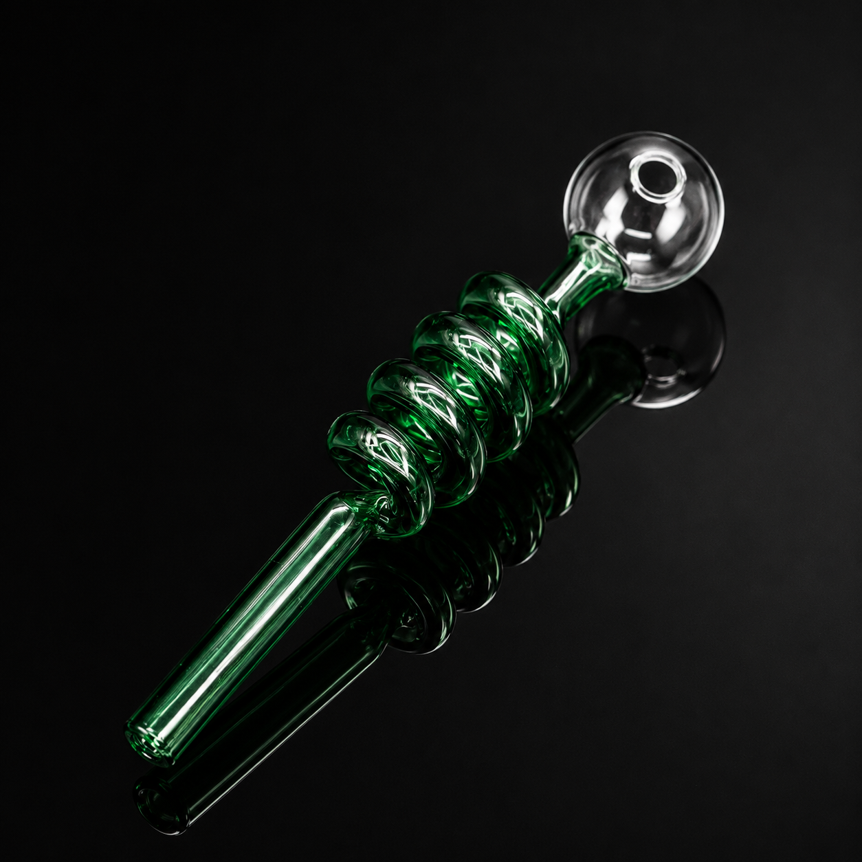 Green glass pipe with twisted design on a black background