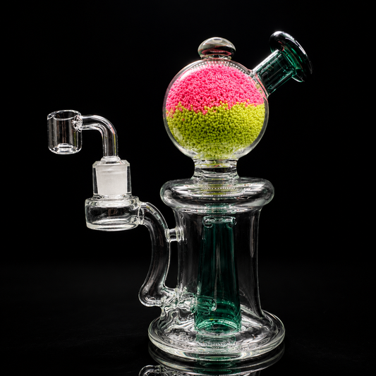 Glass water pipe with colorful beads on a black background