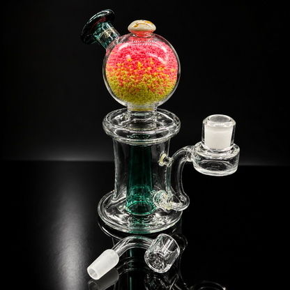 Glass smoking device with colorful chamber on a black background