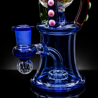 Glass water pipe with blue and clear components on a black background