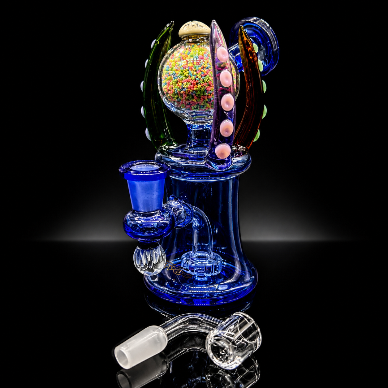 Glass smoking device with colorful interior on a black background