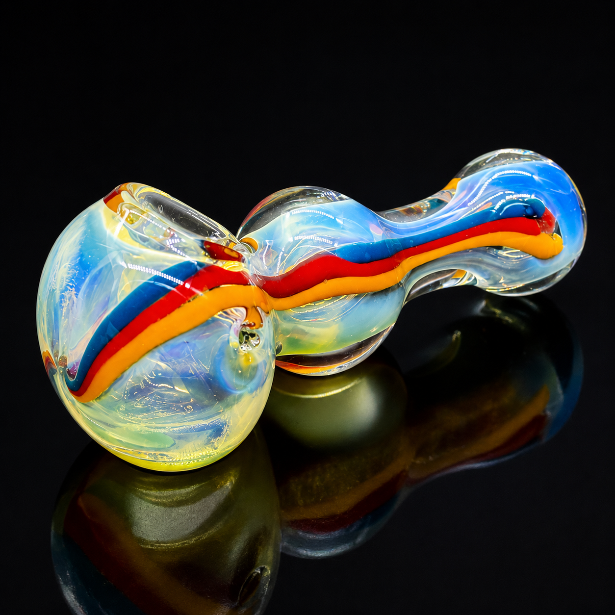 Colorful glass pipe with blue, red, and yellow swirls on a black background