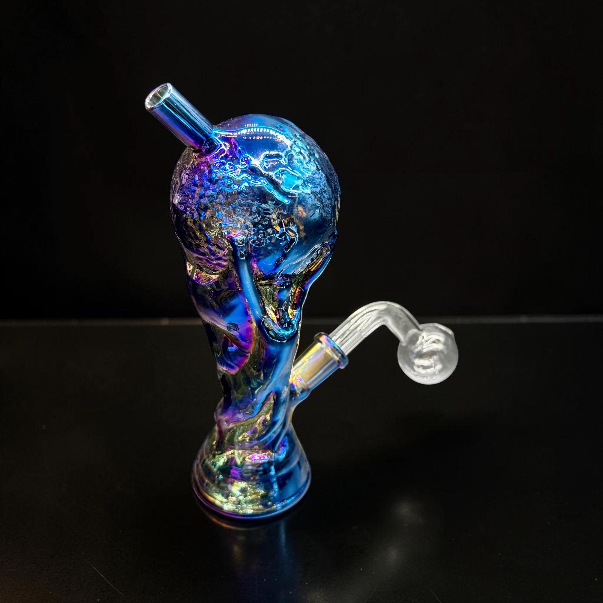 Multicolored glass smoking device on a black background