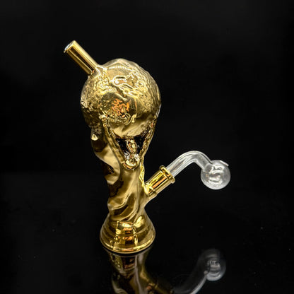 Gold-colored smoking accessory with a clear hose on a black background