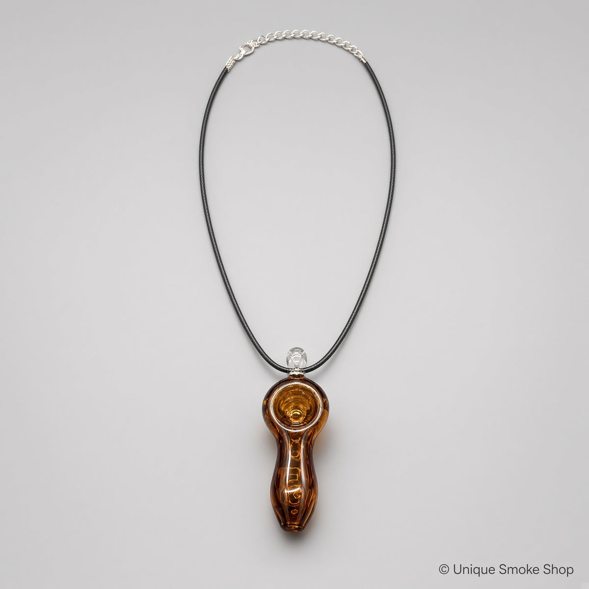 Mini hand-blown amber brown glass pipe necklace with spiral design on black cord