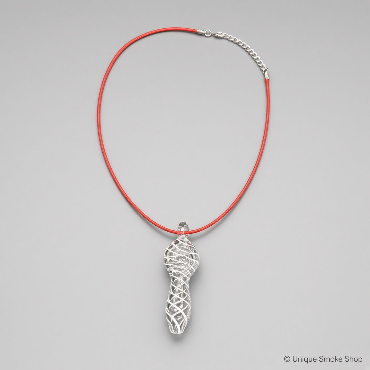 Mini hand-blown clear glass pipe necklace with white swirl pattern on red cord