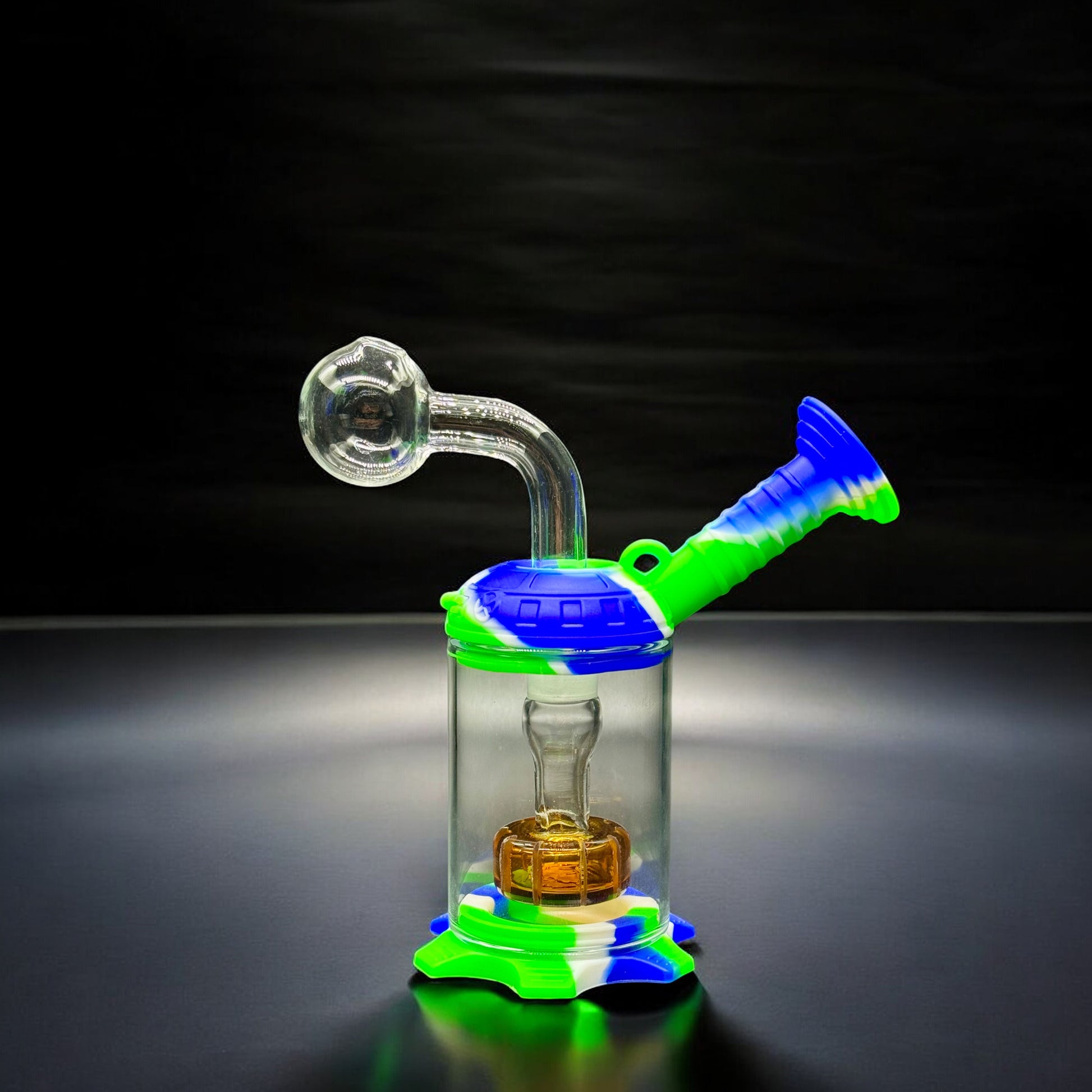 Mini silicone and glass oil burner water pipe in green, white, and blue shown fully assembled on black background
