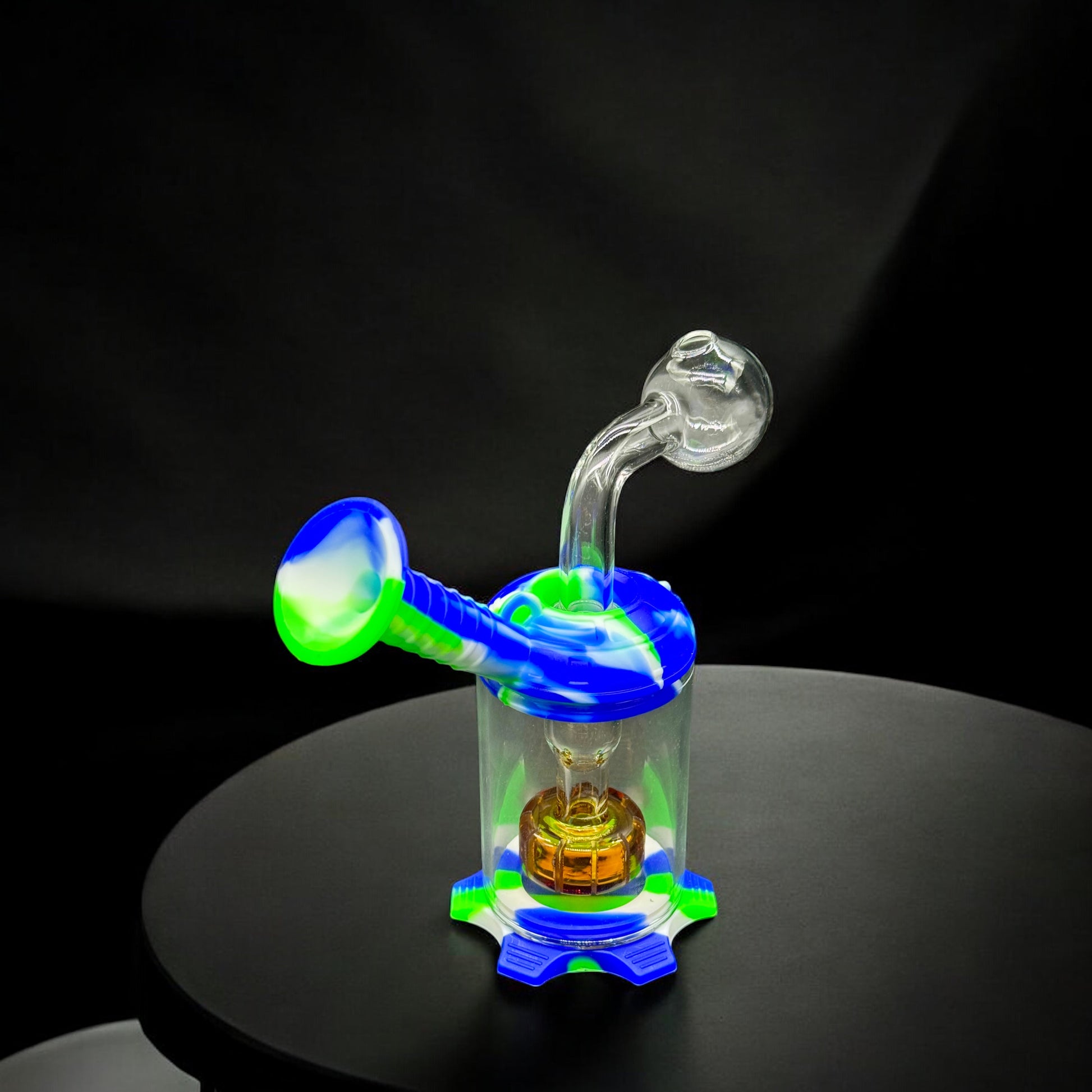 Alternate angle of the mini oil burner pipe in green, white, and blue with clear glass perc visible