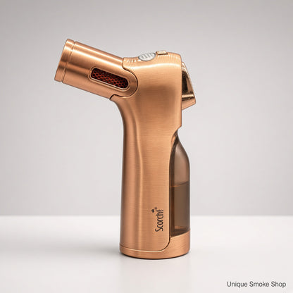 A metallic rose gold torch lighter with a brushed finish, featuring a clear water reservoir and the 'Scordi' brand logo, set against a clean light gray background.