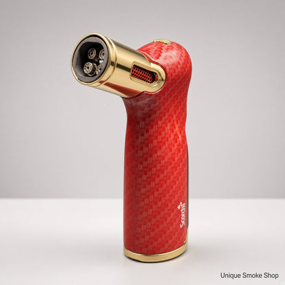 A red carbon fiber torch lighter with gold accents, standing upright on a white surface against a light gray background. The brand name 'Scalpers' is visible on the side.