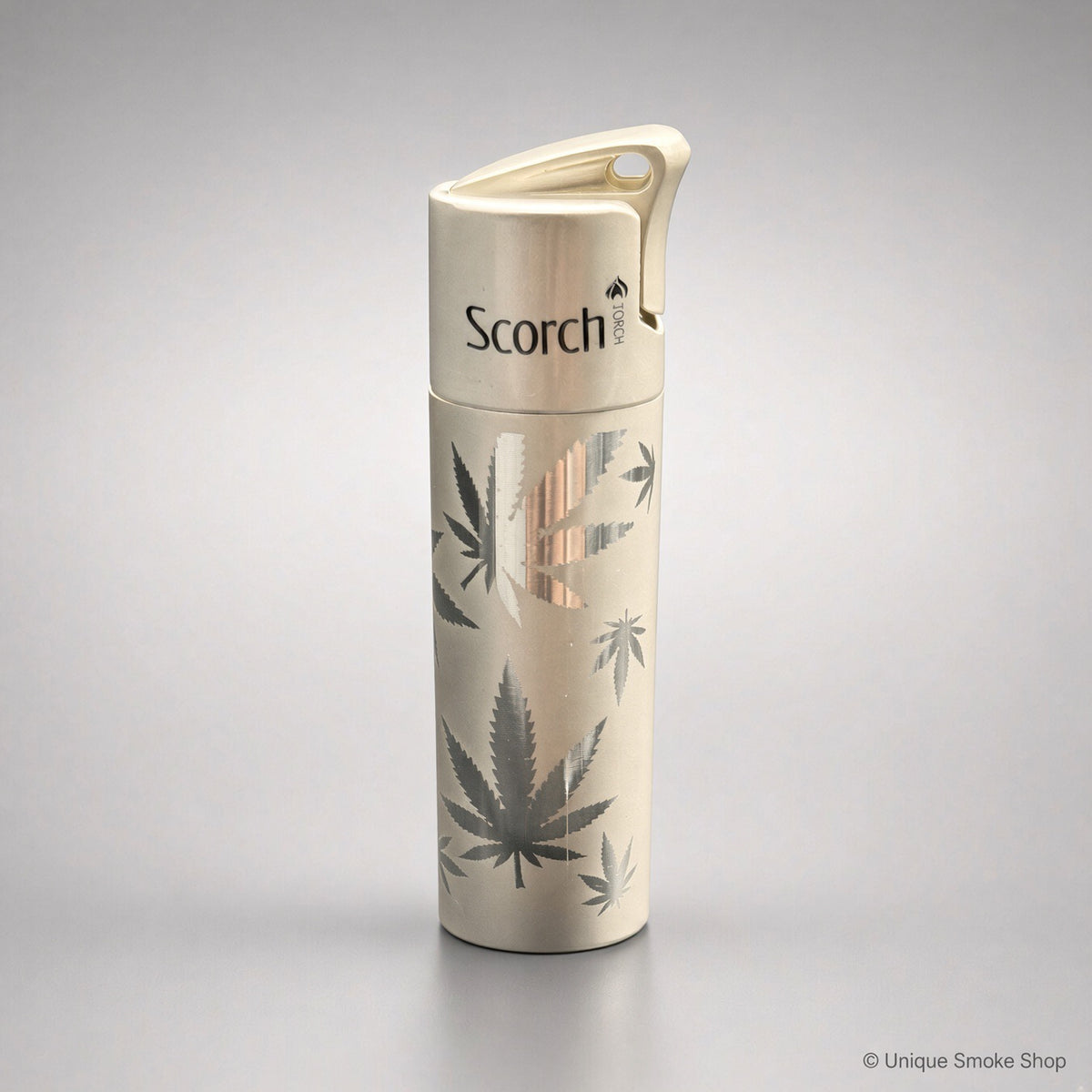 Scorch Torch 61838 cream metal single-flame lighter with cannabis leaf pattern, front view, 3 inches tall.