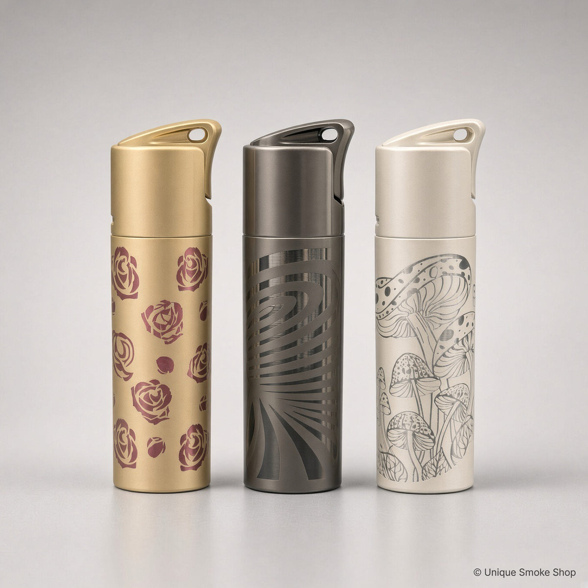 Scorch Torch 61838 group of three metal single-flame lighters: gold rose, gunmetal swirl, and cream mushroom, 3 inches tall.