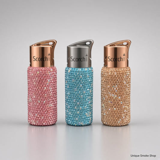 Scorch 61892 rhinestone single flame torch lighters in pink, teal, and champagne on a light gray studio background