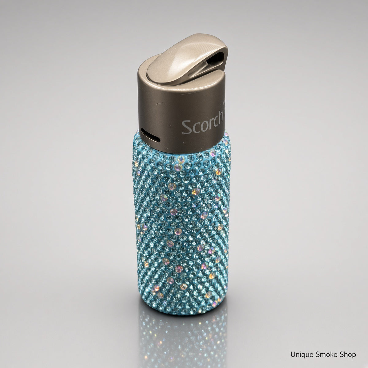 Teal rhinestone Scorch 61892 torch lighter top three-quarter view showing gunmetal lid and Scorch logo