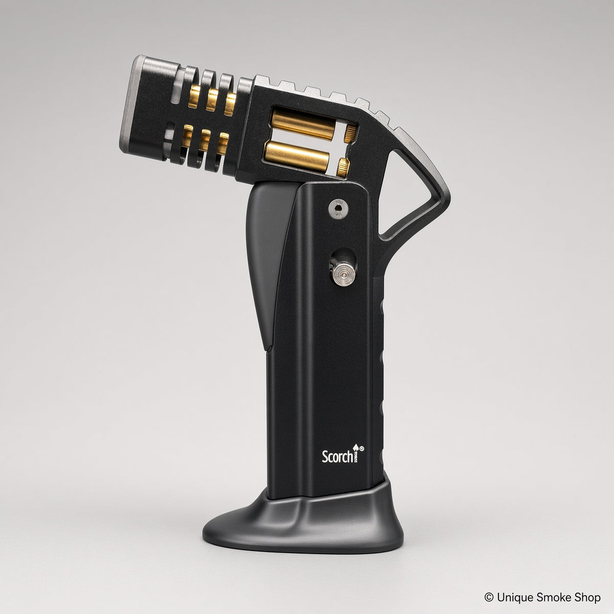 Black Scorch Torch Lighter with gold accents, side view on base – Unique Smoke Shop