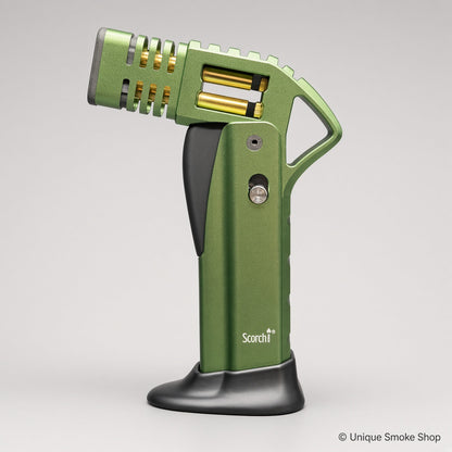 Green Scorch Torch Lighter with gold accents, side view standing on base – Unique Smoke Shop